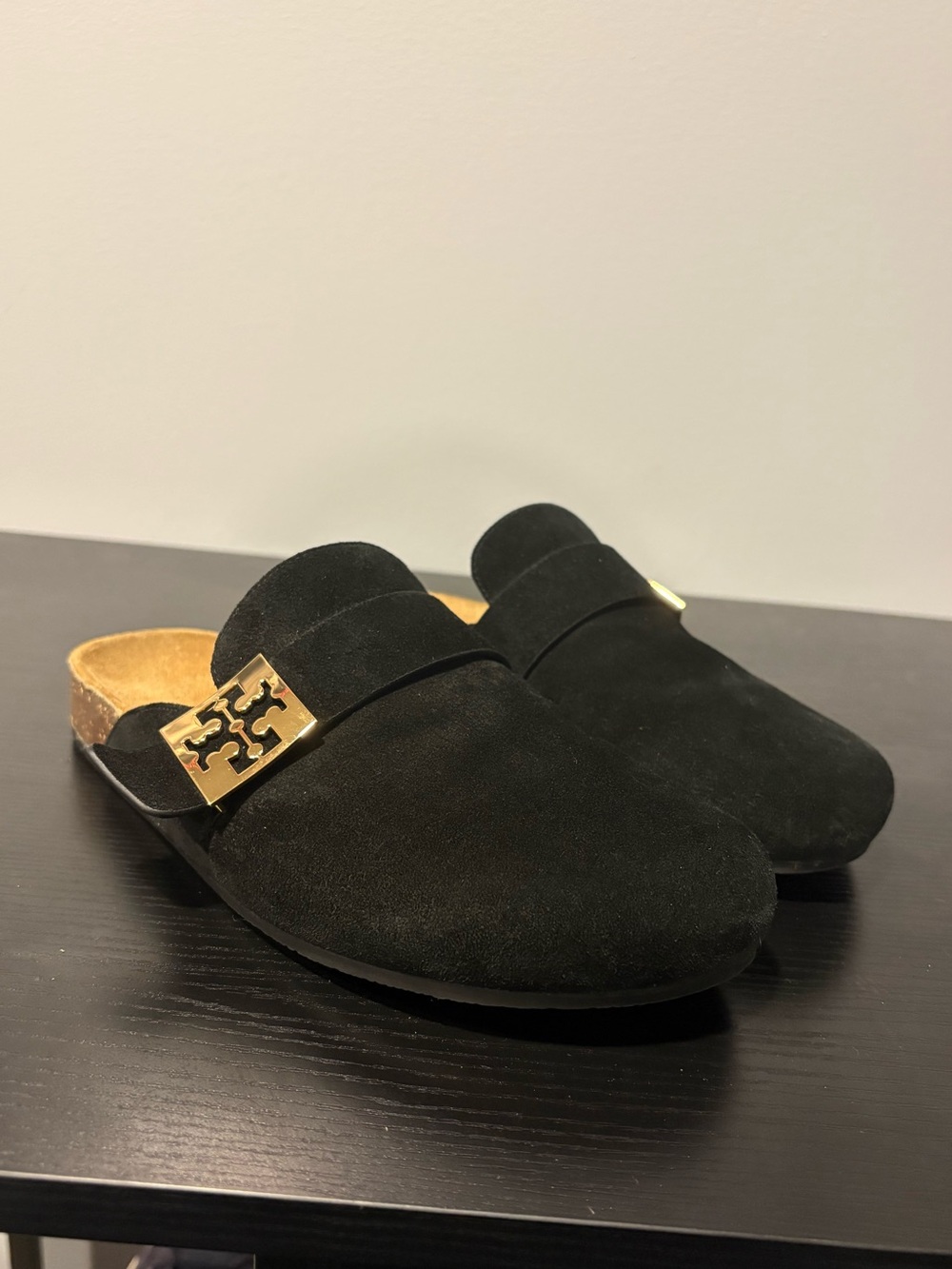 Tory Burch black suede slip-on mules in a size 7.5